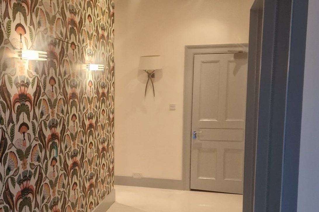 Painted hallway with wallpaper feature wall