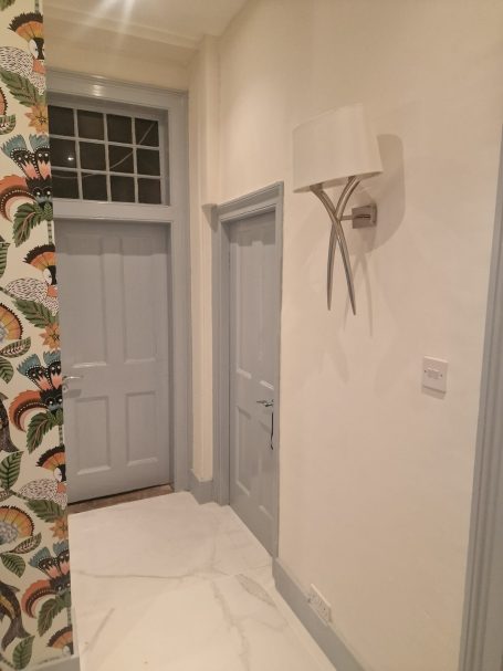 Painted hallway with wallpaper feature wall